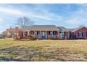 Brick ranch house with front porch and a well-maintained lawn at 116 Country Creek Dr, Kings Mountain, NC 28086