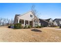 Two-story home with a stone facade and manicured lawn at 14206 Morningate St, Huntersville, NC 28078