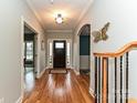 Elegant entryway showcasing hardwood floors and arched doorway, with staircase on right at 1467 Kensington Park Ct, Hickory, NC 28602