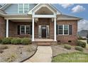 Inviting front porch with classic columns and a brick facade, a welcoming entrance at 1467 Kensington Park Ct, Hickory, NC 28602