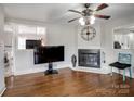 Living room with hardwood floors, fireplace and large TV at 1500 Collier Ct, Charlotte, NC 28205