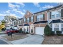 Brick front two-story townhome with attached garage and landscaping at 159 Kallie Loop, Mooresville, NC 28117