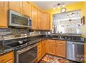 Kitchen with stainless steel appliances and granite countertops at 159 Kallie Loop, Mooresville, NC 28117