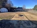 Spacious backyard with shed, firepit, and fenced perimeter at 1704 Fieldcrest Cir, Rock Hill, SC 29732