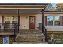 Front porch with wooden steps, railing, and entry door at 1957 Beth Haven Church Rd, Denver, NC 28037