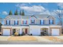 Three-story townhomes with attached garages and manicured lawns at 206 River Clay Rd, Fort Mill, SC 29708