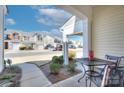 Cozy patio with a bistro table, chairs, and landscaping at 206 River Clay Rd, Fort Mill, SC 29708