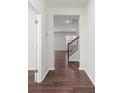 Hardwood floor hallway leading to staircase and living area at 221 Wildflower Dr, Locust, NC 28097