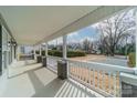 Inviting front porch with white railings and view of the front yard at 2328 Sanders Ave, Charlotte, NC 28216