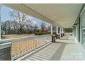 Inviting front porch with white railings and view of the front yard at 2328 Sanders Ave, Charlotte, NC 28216