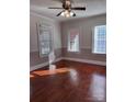 Hardwood floor bedroom with multiple windows and window blinds at 300 S Thompson St, Shelby, NC 28150