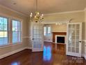 Bright dining room with hardwood floors and French doors leading to the living room at 300 S Thompson St, Shelby, NC 28150