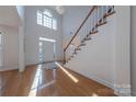 Two-story foyer with hardwood floors, staircase, and a chandelier at 4225 Nathaniel Glen Ct, Matthews, NC 28105