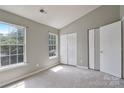 Spacious bedroom with neutral walls, carpet flooring, and double-door closet at 6325 Windsor Gate Ln, Charlotte, NC 28215