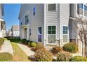 Townhome's side exterior showcasing landscaping and a walkway at 919 Emma Kate Ct, Lake Wylie, SC 29710