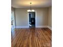 Bright dining room with hardwood floors and chandelier, view into kitchen at 924 E Main St, Albemarle, NC 28001