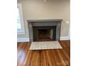 Fireplace with gray mantel and hearth, wood floors at 924 E Main St, Albemarle, NC 28001