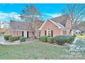 Brick home with mature landscaping and walkway at 1011 Emerson Dr, Mooresville, NC 28115