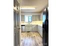 Galley kitchen with light gray cabinets and wood-look floors at 1017 N Center Nw St, Hickory, NC 28601