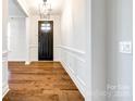 Elegant entryway with hardwood floors and wainscoting at 1056 Emory Ln, Fort Mill, SC 29708