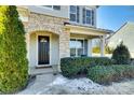 Inviting front entry with stone pillars and a dark wood door at 1056 Emory Ln, Fort Mill, SC 29708