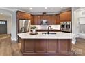 Modern kitchen with wood cabinets, large island, and stainless steel appliances at 1115 Millview Ln, Matthews, NC 28104