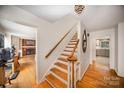 Wooden staircase with a view of the living room and kitchen at 1346 5Th Street Nw Cir, Hickory, NC 28601