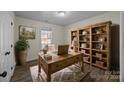 Rustic home office with wood desk, built-in shelving, and area rug at 1417 Wildwood Dr, Kannapolis, NC 28081