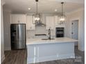 Modern kitchen with white shaker cabinets, quartz countertops, and stainless steel appliances at 1933 Hendricks St, Rock Hill, SC 29732