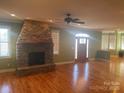 Spacious living room with stone fireplace and hardwood floors at 250 Bost Rd, China Grove, NC 28023