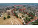 Aerial view showing house, large lot, and surrounding woods at 2633 Jb Denton Rd, Lancaster, SC 29720