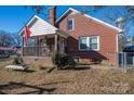 Brick home with a front porch and a fenced yard at 327 S Grove St, Lincolnton, NC 28092