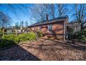 Brick house with deck, mature trees, and a partially visible shed at 3513 Startown Rd, Newton, NC 28658