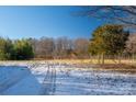 Open lot with snow and tire tracks, partially fenced at 3513 Startown Rd, Newton, NC 28658