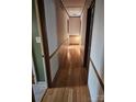 Long hallway with hardwood floors and wood paneling at 44101 Millingport Rd, Richfield, NC 28137