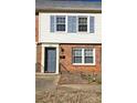 Brick and siding townhouse with blue shutters and a gray door at 4618 Old Lantern Way, Charlotte, NC 28212