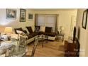 Bright living room featuring an L-shaped sofa and wood floors at 4618 Old Lantern Way, Charlotte, NC 28212