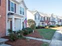 Row of townhomes showcasing a consistent design and well-kept lawns at 6012 Sapwood Ct, Matthews, NC 28104