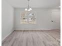 Bright living room with large window and hardwood floors at 709 Ferrell Ave, Charlotte, NC 28216