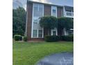 Brick condo building with landscaping and trees at 9401 Old Concord Rd # A, Charlotte, NC 28213