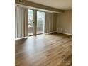 Spacious living room with wood-look floors and sliding doors at 9401 Old Concord Rd # A, Charlotte, NC 28213