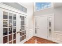 Bright entryway with hardwood floors, a view of an office and french doors at 9729 Cockerham Ln, Huntersville, NC 28078