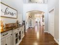 Bright entryway with hardwood floors, an open floor plan, and a view to the living area at 1147 Wagner Ave, Fort Mill, SC 29715