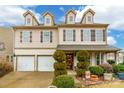 Two-story house featuring beige siding, a two-car garage, and neatly manicured landscaping at 1147 Wagner Ave, Fort Mill, SC 29715