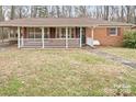 Classic brick home with a welcoming white-railed porch and a well-maintained front lawn at 122 Lowry Row, York, SC 29745