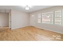 Bright living room featuring hardwood floors, fresh neutral paint and large windows at 122 Lowry Row, York, SC 29745