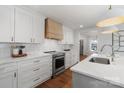 Modern kitchen with white cabinets, quartz countertops and island at 1314 Ordermore Ave, Charlotte, NC 28203