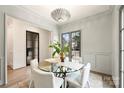 Bright dining room featuring a round glass table and four chairs, with a view to a backyard at 238 Laurel S Ave # A, Charlotte, NC 28207