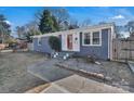 Newly painted gray house with red front door and well-manicured landscaping at 2714 Springway Dr, Charlotte, NC 28205