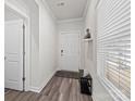 Bright foyer with neutral walls, wood floors, and bench at 310 Hyssop Ct, Fort Mill, SC 29715